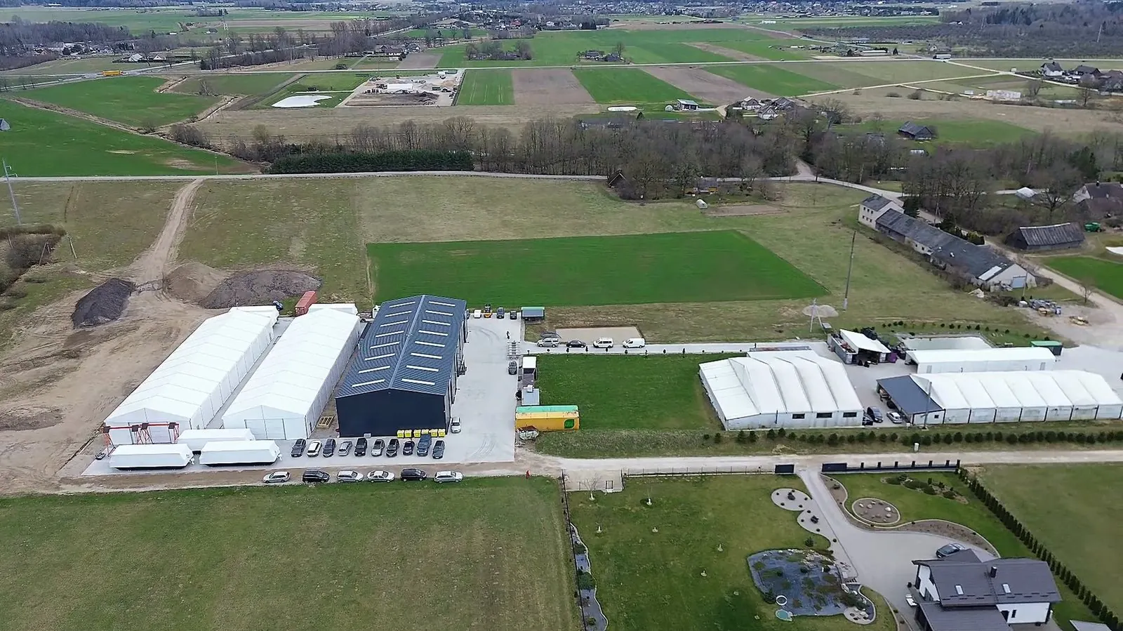 Aerial view of the Deigama boatyard halls among fields in Lithuania